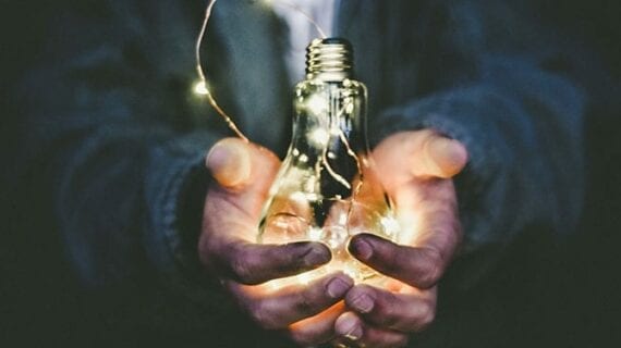 Man holding lightbulb Energy sector key to reviving post-pandemic Canadian economy