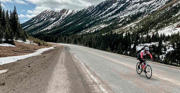 Lisa Monforton, ConnecTour group member, rides the road the Highwood Pass, at 2,206 metres, the highest elevation paved pass in Canada COVID panic? Keep calm and carry on with bike tour planning